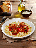 Italian meatballs in tomato sauce on a bed of linguine noodles