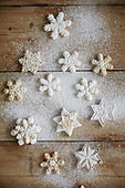 Snowflake cookies with powdered sugar on a wooden table