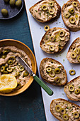 Bean and olive spread on baguette, lemon, olive oils, parsley