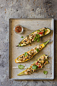 Yellow and green zucchini stuffed with feta, herbs and tomatoes