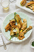 Zucchini flowers filled with ricotta, fried in a beer dough, fresh chives