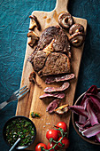 Ribeye steak with chimichurri sauce, mushrooms and salad