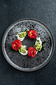 Rolled smoked salmon with avocado on plate in restaurant