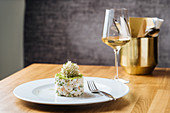 Vegetable salad with decoration on top with glass of wine