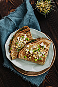 Vegeterian spinach crepes with sprouts and feta