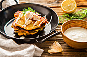 Leek and potato pancakes with smoked trout and sour cream