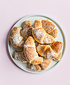 Crescent rolls filled with jam and dusted with icing sugar