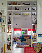 Collection of sculptures on shelves surrounding open doorway leading into living room