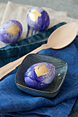 Purple marbled Easter eggs decorated with gold leaf