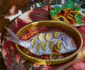 Fried gilt-head bream with lemon, tomatoes and chilli