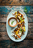 Lentils with oven-roasted vegetables, feta cheese and yoghurt