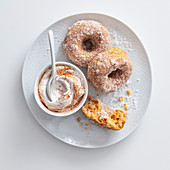 Apple doughnut with cinnamon sugar and cream