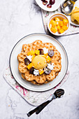 Vegan vanilla waffles with mango sorbet, soya cream and fruit