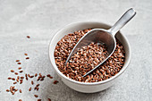 Brown lentils in a bowl and a scoop