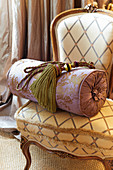 Tassel and bolster on Baroque chair with diamond-patterned upholstery