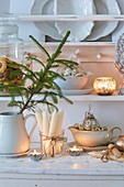 Vintage Christmas decorations and candles on dresser