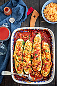 Courgette stuffed with lentils, baked in tomato sauce with beans
