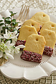 Teabag shaped shortbread biscuits decorated with chocolate glaze and sprinkles