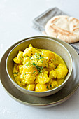 Potato and cauliflower curry with naan bread