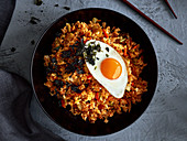 Fried rice with kimchi, vegetables and fried egg (Korea)