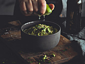 Guacamole being drizzled with lime juice