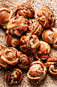 Multiple cinnamon buns with lingonberry jam and pistachios
