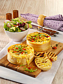 Pasta in cheese wheels with a crispy salad