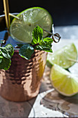 A copper cup with a ginger ale, lime and mint mocktail