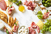 Big plate of appetizers for party of breakfast: gourmet cheese and meat