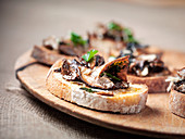 Grilled bread topped with oyster mushrooms