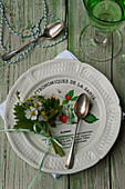Posy of wild strawberry flowers decorating plate