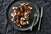 Roasted aubergines, bab ganoush, air-dried tomatoes, toasted pumpkin seeds, buttermilk sauce and pomegranate