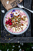 A smoothie bowl with bananas, berries and almonds