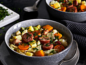 Cabbage stew with pumpkin and Mettenden (smoked pork sausage)