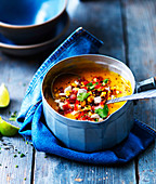 Pumpkin soup with sweetcorn salsa in a bowl