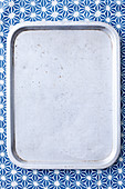 Grey tray on blue background