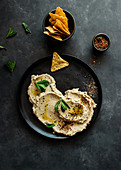 Black plate with eggplant and cauliflower dip