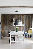 Country-house-style dining room with rustic board wall