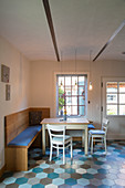 Dining area with corner bench in kitchen-dining room with tiled floor