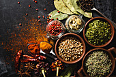 Different kinds of natural aromatic spices placed on slate surface