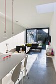 Minimalist living room with polished concrete floor and skylight