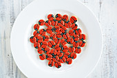 Lots of little ladybird cookies on a plate