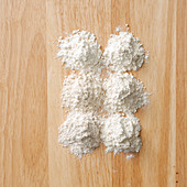 Wheat flour types on a wooden background