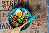 Ramen soup with beef, spring onions, sprouts and an egg