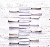 Vintage knives on a white wooden background