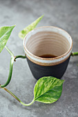 Black coffee in a handmade black clay cup