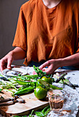 Woman makes spring vegetable salad