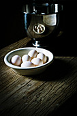Oak table top with bowl of hens eggs, _