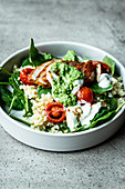 Fitness bowl with chicken breast, bulgur, spinach and pesto