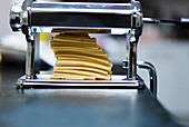Rolling fresh pasta with a pasta machine